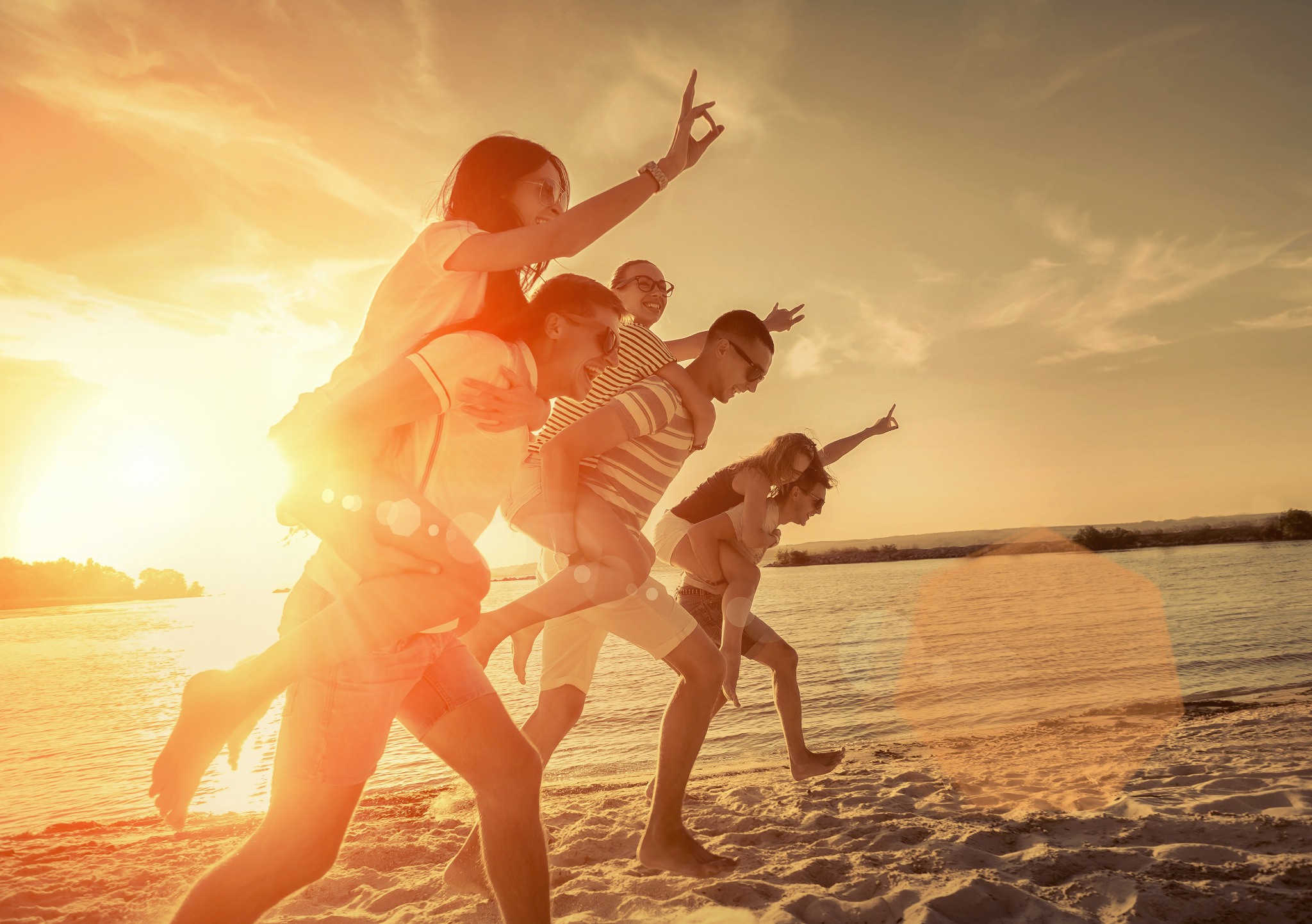 Reisegruppe am Strand bei Sonnenuntergang